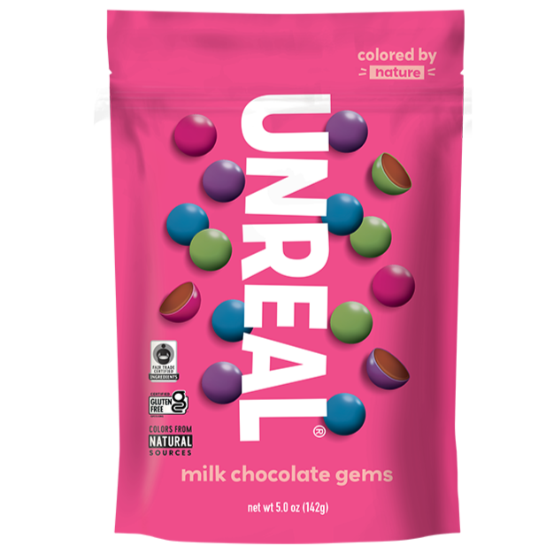 Unreal milk chocolate gems package with colorful chocolate pieces on pink background