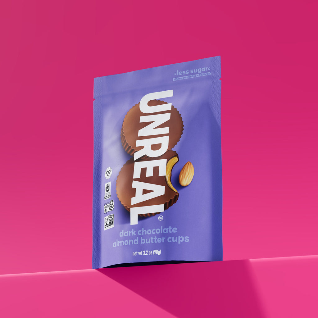 UNREAL dark chocolate almond butter cups package with less sugar, vegan, fair trade, gluten free, and non-GMO labels