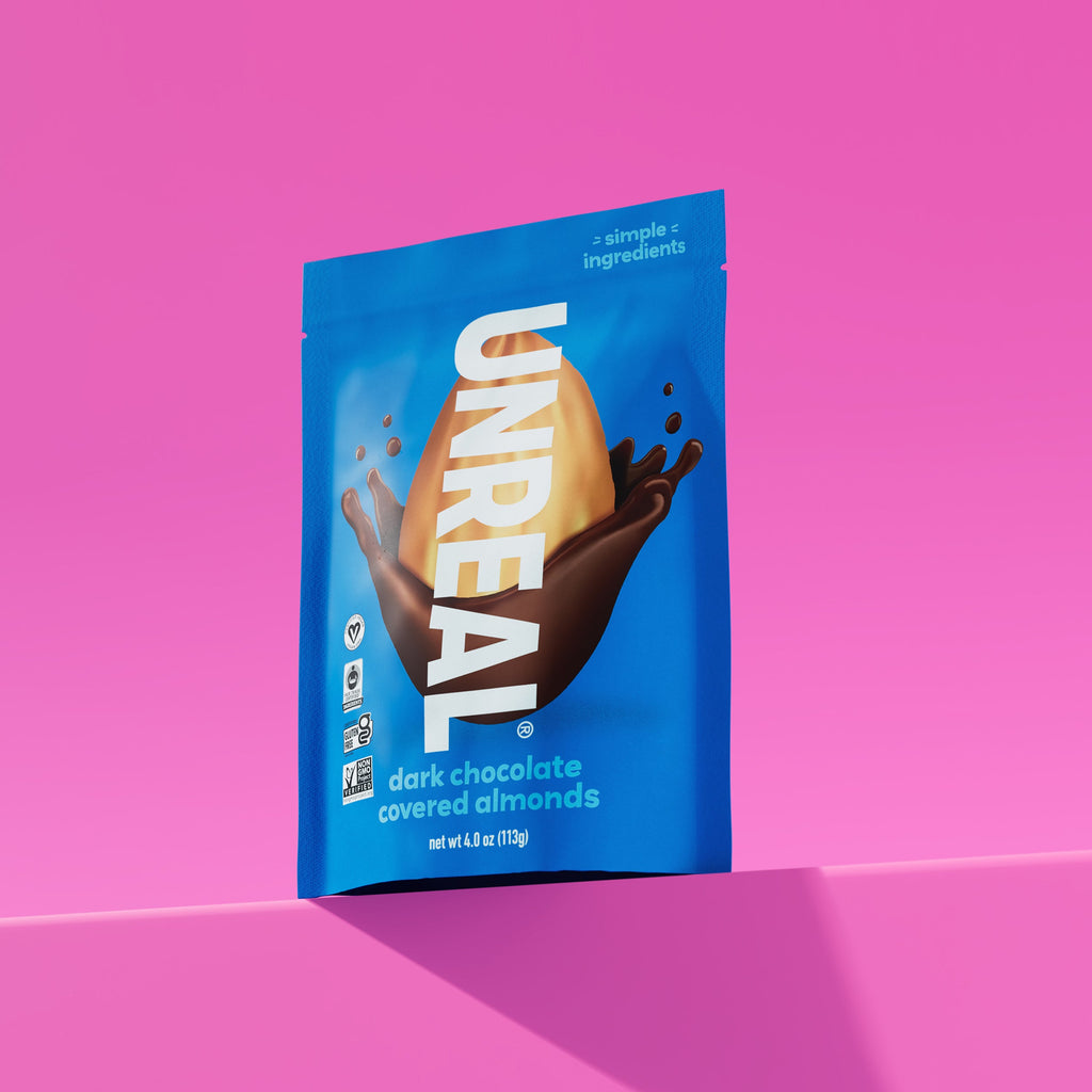 UNREAL dark chocolate covered almonds package with simple ingredients and certification icons on blue pouch