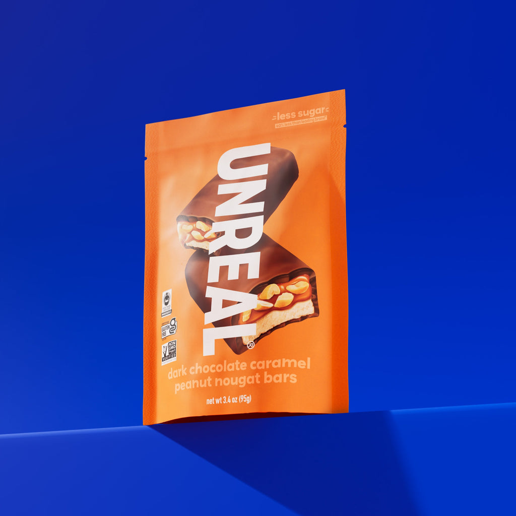 UNREAL dark chocolate caramel peanut nougat bars package with less sugar claim and certification logos