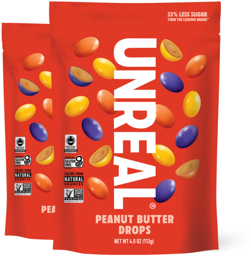 Front of two Peanut Butter Drops bags with UNREAL logo, candy pieces, and 33 percent less sugar claim